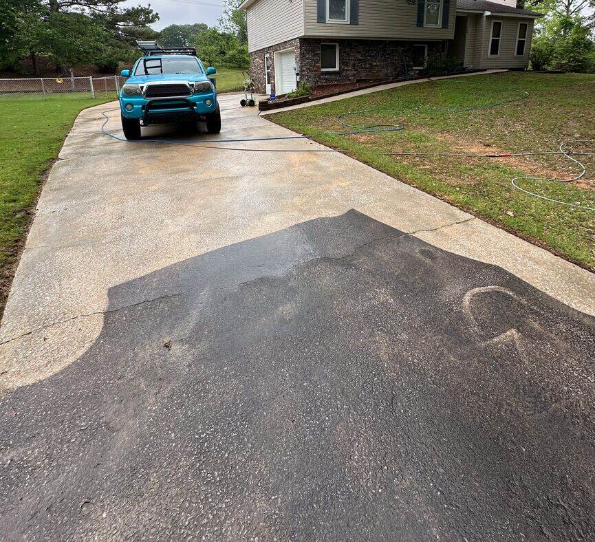 Driveway surface cleaning service showing a visual contrast between clean and dirty concrete for Pressure Washing McCalla.